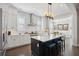Bright kitchen with white cabinets, subway tile backsplash, a large island with seating, and stainless steel appliances at 184 Clearblue Loop, Summerville, SC 29486