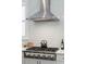 Close-up of the modern kitchen with stainless steel range hood and sleek stovetop over a subway tile backsplash at 184 Clearblue Loop, Summerville, SC 29486