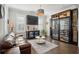 Stylish living room with a leather sofa, wine refrigerator, custom cabinets, and a climate-controlled wine storage unit at 184 Clearblue Loop, Summerville, SC 29486