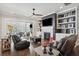 A comfortable living room with a fireplace, built-in shelving, and a sliding glass door at 184 Clearblue Loop, Summerville, SC 29486