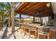 Enjoy outdoor living at its finest with this property's bar seating, built-in grill, and views of the backyard pool at 184 Clearblue Loop, Summerville, SC 29486