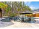 Luxurious pool area with stone surround, integrated spa, waterfall feature, and Adirondack chairs at 184 Clearblue Loop, Summerville, SC 29486