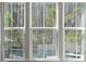 A luxurious pool and patio are seen through a window with light curtains at 184 Clearblue Loop, Summerville, SC 29486