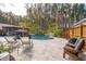 Enjoy outdoor living in this home's backyard, complete with a pool, multiple seating areas, and mature palm trees at 184 Clearblue Loop, Summerville, SC 29486
