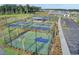 Aerial view of community sports courts, featuring pickleball and basketball, surrounded by lush landscaping at 184 Clearblue Loop, Summerville, SC 29486