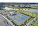 Aerial view of community tennis and pickleball courts near a scenic pond at 184 Clearblue Loop, Summerville, SC 29486