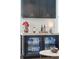 Close-up of a stylish wet bar featuring custom cabinets, a beverage refrigerator, and elegant countertop decor at 184 Clearblue Loop, Summerville, SC 29486