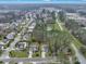 Aerial view of a residential neighborhood with well-manicured lawns, mature trees, and a tranquil pond at 2004 Hammond Dr, Mount Pleasant, SC 29466