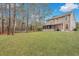 Large backyard featuring a screened porch, sprawling lawn, and tall trees providing ample shade and privacy at 2004 Hammond Dr, Mount Pleasant, SC 29466