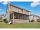 Spacious backyard with a screened porch, well-maintained lawn, and the exterior of a tan home at 2004 Hammond Dr, Mount Pleasant, SC 29466