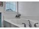 Bright bathtub area featuring a garden flower, chrome fixtures, and natural light from the window at 2004 Hammond Dr, Mount Pleasant, SC 29466