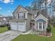 Charming two-story home featuring a two-car garage, front garden, and landscaped yard at 2004 Hammond Dr, Mount Pleasant, SC 29466
