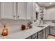 Bright kitchen boasts marble countertops, stainless steel appliances, and custom shelving at 2004 Hammond Dr, Mount Pleasant, SC 29466