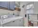 Cozy laundry room features modern washer and dryer and ample storage space at 2004 Hammond Dr, Mount Pleasant, SC 29466