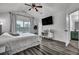 Bright main bedroom featuring a large window, vaulted ceiling, TV, and luxury vinyl plank flooring at 2004 Hammond Dr, Mount Pleasant, SC 29466