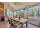 Charming sunroom featuring tiled floors, a ceiling fan, and bright, airy windows overlooking the serene backyard at 2004 Hammond Dr, Mount Pleasant, SC 29466