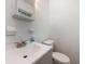 Compact half bathroom with a modern sink, gray vanity, framed mirror, and tiled floor at 203 Elliott Dr, Ladson, SC 29456