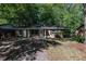 Well-maintained brick home with a welcoming entrance, surrounded by mature trees, offering a serene and private setting at 203 Elliott Dr, Ladson, SC 29456