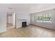 Cozy living room featuring tile flooring, a white fireplace, and a door leading to the outside at 203 Elliott Dr, Ladson, SC 29456