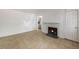 Spacious living room featuring tile flooring, a white fireplace, and open access to the kitchen at 203 Elliott Dr, Ladson, SC 29456