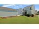 The backyard boasts a screened porch and a well-manicured lawn, perfect for outdoor relaxation and activities at 211 Terrace View Dr, Summerville, SC 29486