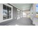 Side view of the covered porch showing the gray siding, white windows, and a view of the neighborhood at 213 Terrace View Dr, Summerville, SC 29486
