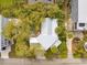 Aerial view of a house with a backyard firepit, a lush green yard, and nearby beach access at 217 E Huron Ave, Folly Beach, SC 29439