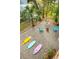 Outdoor backyard space with surfboards, a fire pit, chairs, and a palm tree at 217 E Huron Ave, Folly Beach, SC 29439