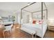 A spacious bedroom features a four-poster bed, a bunk, and a comfortable workspace at 217 E Huron Ave, Folly Beach, SC 29439