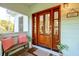 Charming front door entrance with glass panels, bench seating, and stylish decor at 217 E Huron Ave, Folly Beach, SC 29439