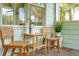Cozy front porch features seating and a table, perfect for enjoying the outdoors at 217 E Huron Ave, Folly Beach, SC 29439