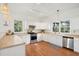 Bright kitchen with stainless steel appliances, generous counter space, and ample cabinet storage bathed in natural light at 217 E Huron Ave, Folly Beach, SC 29439