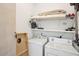 This laundry room has a washer, a dryer, shelving, and storage space at 217 E Huron Ave, Folly Beach, SC 29439