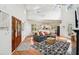 Open-concept living room with high ceilings, hardwood floors, and a comfortable seating area at 217 E Huron Ave, Folly Beach, SC 29439