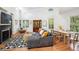 Open living area with a fireplace, high ceilings, and a comfortable seating area bathed in natural light from multiple windows at 217 E Huron Ave, Folly Beach, SC 29439