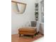 Cozy sitting area with a comfortable armchair, leather ottoman, and built-in shelving, bathed in soft natural light at 217 E Huron Ave, Folly Beach, SC 29439