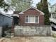Charming brick home features a well-maintained facade with a concrete block foundation and awning over the front porch at 227/229/3 Fishburne/Woodall St, Charleston, SC 29403