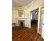 Cozy living room is open to another room, and features wood floors and a decorative fireplace at 227 Fishburne St, Charleston, SC 29403