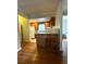 Cozy kitchen with wooden cabinets, a breakfast bar with two stools, and bright natural light at 227/229/3 Fishburne/Woodall St, Charleston, SC 29403