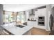 Modern kitchen with white cabinets, stainless steel appliances, granite countertops, and an eat-in island at 257 Camellia Bloom Dr, Moncks Corner, SC 29461