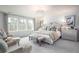 Bright bedroom with a decorative chandelier, plush seating, and large windows for ample natural light at 261 Camellia Bloom Dr, Moncks Corner, SC 29461