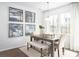 Bright dining area with a rustic wood table, comfortable seating, and natural light at 261 Camellia Bloom Dr, Moncks Corner, SC 29461