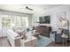 Cozy living room with modern furniture, shiplap accent wall, and ample natural light at 261 Camellia Bloom Dr, Moncks Corner, SC 29461