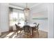 Elegant dining area with modern chandelier, shiplap accent wall, and ample natural light at 265 Camellia Bloom Dr, Moncks Corner, SC 29461