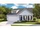 Charming single-Gathering home with a two-car garage, inviting front porch, and manicured lawn at 265 Camellia Bloom Dr, Moncks Corner, SC 29461