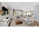 Bright and airy living room with hardwood floors and modern decor, seamlessly flowing into the kitchen at 265 Camellia Bloom Dr, Moncks Corner, SC 29461