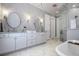 Spacious bathroom featuring dual sinks, soaking tub, glass shower and marble floors at 2805 Stay Sail Way, Mount Pleasant, SC 29466
