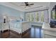 Charming bedroom featuring wood floors, a ceiling fan, and an abundance of natural light from the large window at 2805 Stay Sail Way, Mount Pleasant, SC 29466