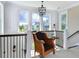 Bright hallway with a cozy seat, black metal railing, and large windows offering neighborhood views at 2805 Stay Sail Way, Mount Pleasant, SC 29466