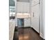 Butler's pantry with white cabinets, mini-fridge, countertop, and dark wood floors at 2805 Stay Sail Way, Mount Pleasant, SC 29466